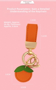 Detailed view of orange leather keychain with dimensions and stitching on pink background