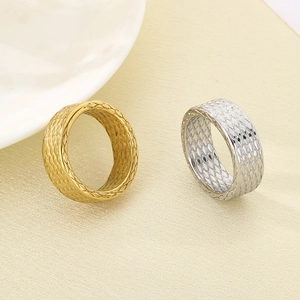 Detail of vintage punk rhombus grid texture on gold and silver stainless steel rings