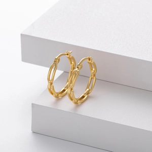 Elegant S925 sterling silver hollow chain hoop earrings in gold finish on white steps