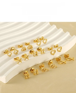 Detailed macro shot of gold-plated stainless steel heart and geometric stud earring set