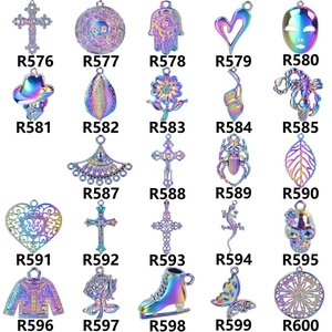 Macro display of 24 colorful alloy angel wing and cross pendants for DIY jewelry making