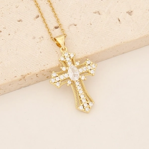 Detailed macro view of 18K gold plated cross pendant with colorful zircon stones