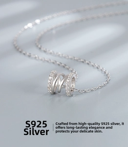 Macro view of S925 sterling silver triple-ring spiral pendant with pavé set zircon stones