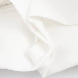 Close-up of white bubble hem dress fabric showing premium knit texture and stitching