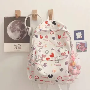 Cute cartoon heart print backpack for students with pink flower plush charm accessory