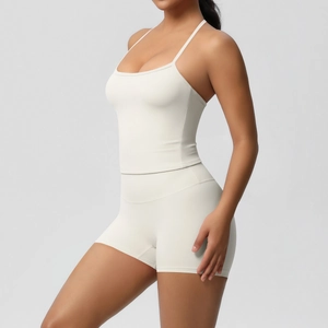 Detailed side view of ivory yoga set with thin strap sports bra and high waist shorts