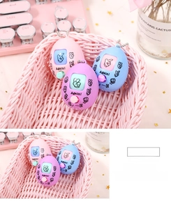 Macro view of rock-paper-scissors game egg keychains in pastel pink, blue, and purple tones