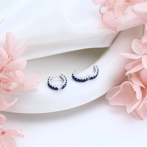 Detail view of S925 sterling silver hoop earrings with rectangular blue zircon stones