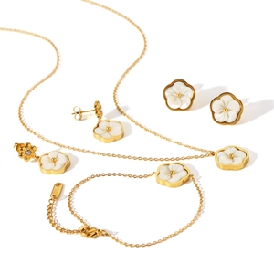 Stainless steel jewelry set featuring white flower pendants with gold plating finish