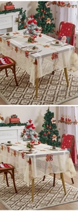 Detail of cream lace Christmas tablecloth with red bow and bell embroidery patterns