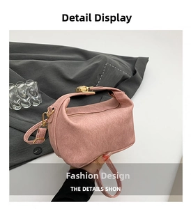 Detail of pink faux suede pillow bag featuring gold metal hardware and slim strap