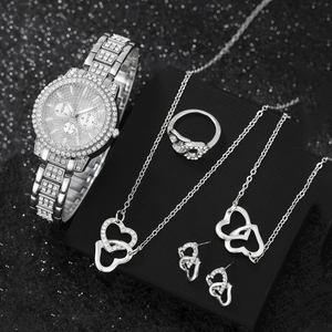 Detail of silver heart jewelry set including watch, ring, and earrings with crystals