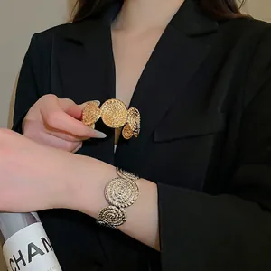 Baroque textured wide open cuff bracelet in gold and silver finish with spiral pattern