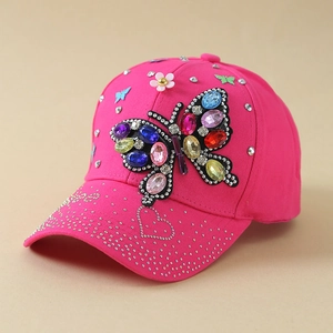 Detailed view of handmade crystal butterfly and rhinestones on the rose pink baseball cap