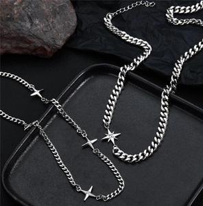 Macro view of silver star pendants and Cuban chain on minimalist titanium necklaces