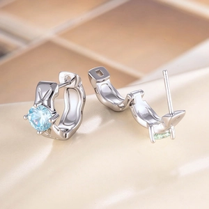 Minimalist silver hoop earrings with round light blue zircon stones in a sleek geometric style