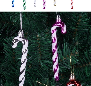 Close-up of candy cane Christmas tree ornaments with glitter stripes in various colors