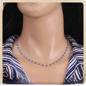 Detailed view of evil eye beaded necklace in golden finish worn on a jewelry model
