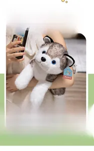 Close-up of husky plush toy with blue eyes and soft fur held by a model in home setting