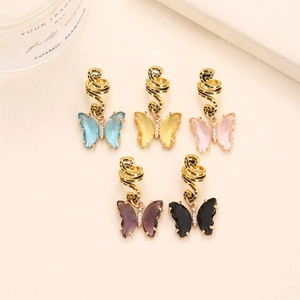 Five gold spiral ear cuffs with crystal butterfly charms in blue yellow pink purple and black