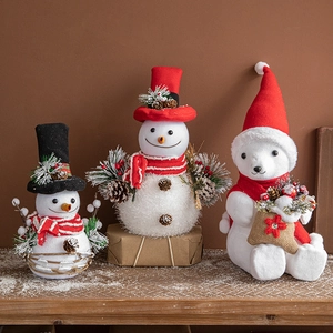 Christmas foam plush snowmen and polar bear figures with red scarves and hats on snowy wood