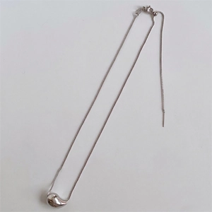 Detailed view of silver teardrop pendant with adjustable box chain and mirror finish