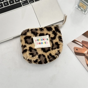 Flat lay of leopard print plush coin purse with zipper and stylish embroidery detail