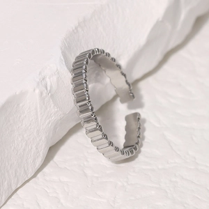 Elegant adjustable silver stainless steel ring featuring unique vertical ribbed texture