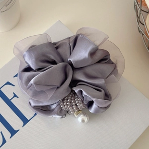 Detail of grey satin scrunchie with sheer organza ruffles, purple beads and pearl pendant