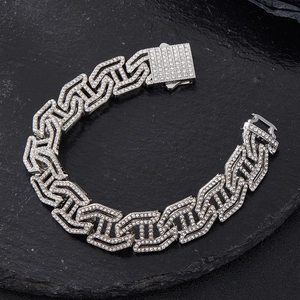 Macro shot of silver-toned iced out Cuban link bracelet with sparkling rhinestones detail