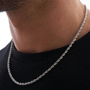 Close-up of minimalist S925 sterling silver twist chain necklace worn on a model's neck