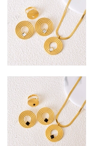 Detailed set of gold snake chain necklace and geometric ring on a stone texture backdrop