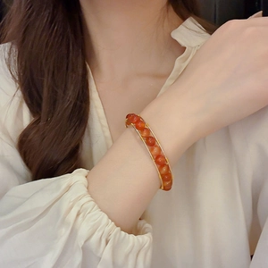Detailed view of handmade beaded bracelet with tiger eye stones and gold wire wrapping