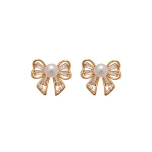 Elegant bow-shaped earrings with gold base, cubic zirconia accents and dangling pearls