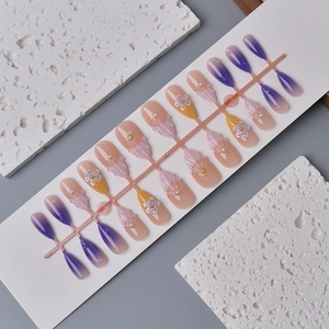 Purple almond press-on nails with 3D flower pearl and shell texture designs