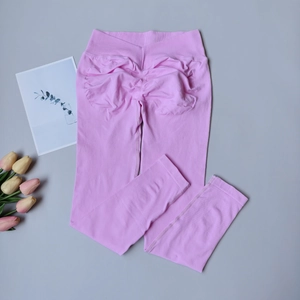 Détail du legging de yoga mauve avec taille croisée et design froncé pour les fesses