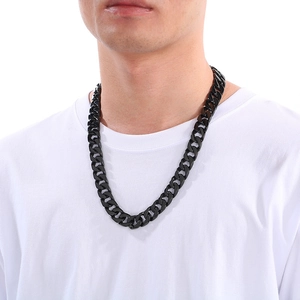 Close-up of 15mm black stainless steel flat Cuban link necklace worn on a model