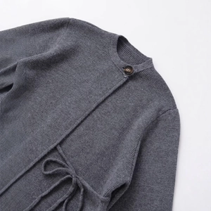 Minimalist grey knit cardigan coat with round neck, single button, and waist tie design