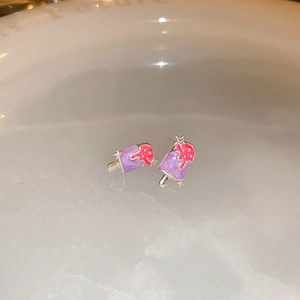 Close-up of cute purple and pink popsicle earrings with silver stars and small crystals