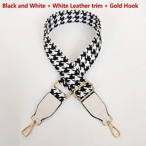 Detail of adjustable houndstooth shoulder strap with white leather and gold metal hooks