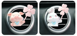 Detailed view of cute pig and rabbit air vent clips with spinning pink windmills