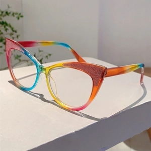 Close-up of cat eye glasses frames with rainbow gradient and glitter embellishments