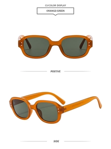 Detail view of vintage oval orange frames with green lenses and silver rivet accents