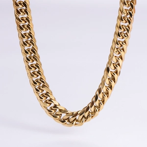 Macro view of 18k gold plated Cuban link chain with high polish and dense links