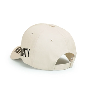Detail view of New York City embroidery and adjustable metal buckle on beige cotton cap