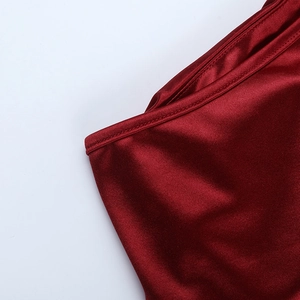 Gros plan détaillé du tissu en satin bordeaux montrant la texture et la couture