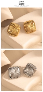 Macro shot of geometric square earrings with spiral texture in gold and silver finish