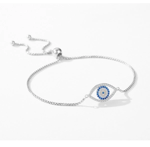 Detail of S925 silver Evil Eye bracelet with blue and white zircons on white background