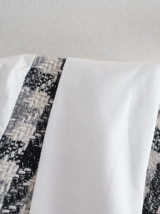 Vista dettagliata della cucitura del tessuto bianco e della trama in tweed bianco e nero