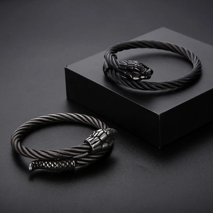 Macro shot of dual snake head twisted wire bracelets in matte gunmetal black finish
